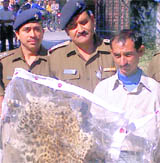 A poacher with a leopard skin in police custody.