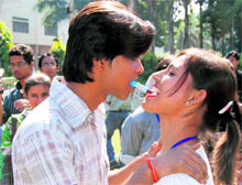A student applies lipstick to other student during the Thomso cultural festival in Roorkee