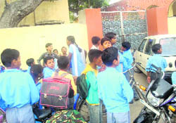 School kids outside the locked school at Lambi near Dabwali on Friday.