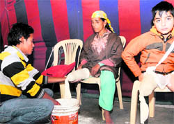 A volunteer attends to a physically-challenged woman during a medical camp organised by the Border Road Organisation Wives Welfare Association and the All India Marwari Yuva Manch of Rajasthan in Srinagar on Friday