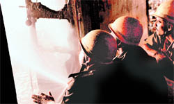 Firefighters try to douse the flames at the Chemistry Department of Presidency University in Kolkata