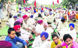 Farmers block rail traffic near Bughipura village on the outskirts of Moga town