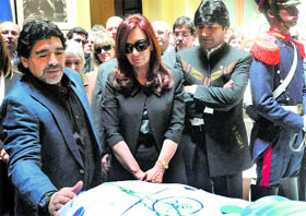Argentina President Cristina Fernandez (centre) and soccer legend Diego Maradona (left) stand by the flag-draped casket containing the remains of former President Nestor Kirchner in Buenos Aires on Thursday.