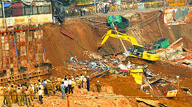 Rescue work in progress after a portion of a wall collapsed at an underground multi-level parking site being constructed at Chandni Chowk in Old Delhi on Saturday morning.
