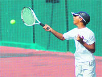 A player in action at the 11th Uttarakhand State Open Junior Tennis Tournament in Dehradun on Saturday.