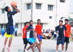A match in the district-level Basketball Championship in progress at the Parade Ground in Dehradun on Saturday.