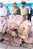 MC officials and the police with the seized bags of khoya at the Jammu Tawi Railway Station 