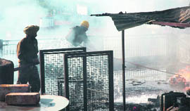 Fire fighters douse the flames at an industrial unit in Halo Majra, Chandigarh, on Sunday.