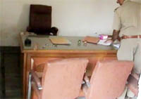 A policeman checks the office of Adhikaar - The Rights Path, after it was ransacked on Sunday morning in Gurgaon.