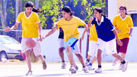 A match in the District-Level Basketball Championship in progress in Dehradun on Sunday.