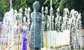 A statue of Swami Vivekanand next to a fountain at Aryan School in Dehradun.