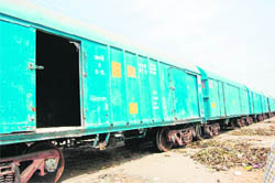 Wagons in a special railway rake with broken doors at the Kaithal railway station. 