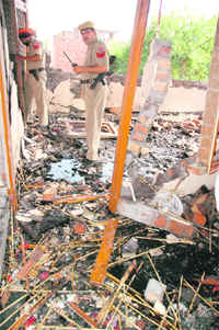 Policemen inspect the blast site at an illegal firecracker unit in Amritsar on Sunday. 