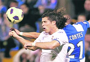 Real Madrids Cristiano Ronaldo (L) vies with Hercules' David Cortes during their Spanish League match in Alicante on Saturday. 