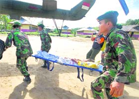 A tsunami victim is evacuated by soldiers to Padang city from Sikakap district in Indonesia