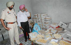 Health and police officials conducting a raid at the house of a sweets supplier in Bathinda on Monday.