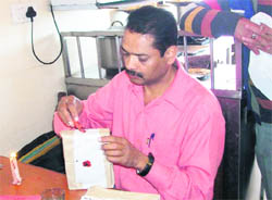 A health official seals a sample of sweets in Mussoorie on Monday. 
