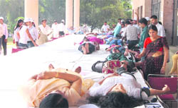 Volunteers donate blood while others wait for their turn at a blood donation camp organised at Hisar.