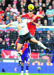 Bolton Wanderers Kevin Davies (L) vies with Liverpool's Sotirios Kyrgiakos on Sunday.