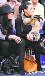 Kim Kardashian (R) watches the second half of the game between New Jersey Nets and Miami Heat in  New Jersey on Sunday.