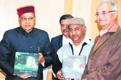 Chief Minister PK Dhumal releases Vijay Sharmas book on Kangra art.