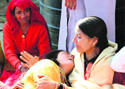 The mother of leopard victim Sagar being consoled by village women in Mandi.