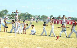 Students of Sainik School at Sujanpur Tihra present acrobatic exercises during the 33rd Raising Day function