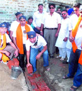 Members of the Punjabi Wolves launch a housing project for poor families at Dawida Rehana village in Hoshiarpur.
