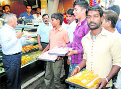 MC staff check sweets and milk products in a drive against adulterated milk in Nai Basti Market 
