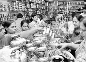 Women buy utensils on Dhanteras at a shop in Chandigarh on Wednesday.