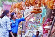 Women buy decorative items for Divali at Sarojini Nagar Market in New Delhi