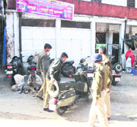 Policemen move vehicles parked wrongly at the Landour Chowk in Mussoorie.