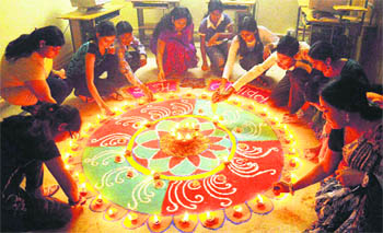 Students take part in a "rangoli" competition at Aparna Women Polytechnic College in Faridabad