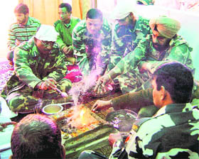 CRPF officers and jawans perform havan at their camp in Pulwama on Wednesday. 