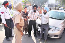 Riot victims request policemen to allow them to block the road at Bharat Nagar Chowk in Ludhiana on Wednesday