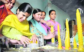 Visually impaired children make candles to be sold on Diwali in the city on Wednesday