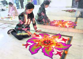 A student takes part in rangoli making contest at De Samar Academy in Ludhiana