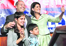 South Carolina Governor-elect Nikki Haley, with her husband Michael, daughter Rena and son Nalin, gives a thumbs up after her acceptance speech in Columbia on Wednesday. Nikki received 52 per cent of the votes while her Democrat rival Vincent Sheehan polled 46 per cent. She became the second person of Indian origin to be Governor of an American state after Bobby Jindal was elected to lead Louisiana in 2007. 