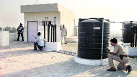 Policemen take positions on the roof of an unoccupied building during a mock drill in Kaithal.