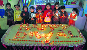 Schoolchildren light the lamps on the eve of Divali in Shimla on Thursday.