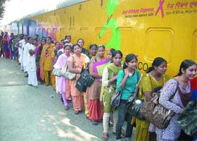 People queue up to watch an exhibition in the Red Ribbon Express train in Phagwara