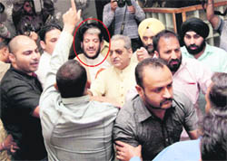 BJYM activists disturb a press conference of Jammu and Kashmir Democratic Freedom Party leader Shabir Shah (encircled) in Jammu 