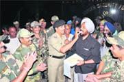 BSF jawans exchange sweets on the eve of Divali on the Indo-Pak border at Suchetgarh octroi post in Jammu