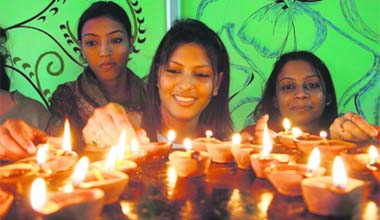 Gearing up for the D-day: Girls light earthen lamps on the eve of Divali in Jammu