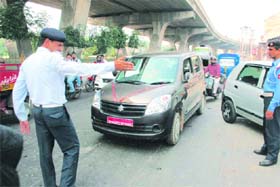 A policeman tries to regulate traffic in Jammu