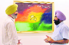 Jaswant Zafar, a noted Punjabi writer (left), during his first solo exhibition of paintings at Gallery Artmosphere under the title Ek-Onkar in Ludhiana on Thursday.