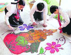 Students of GMT School make a rangoli during a competition in Ludhiana on Thursday.