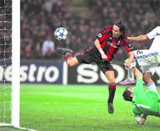 AC Milan's forward Filippo Inzaghi (L) scores against Real Madrid during their Champions League match at the San Siro in Milan on Wednesday.