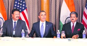 US President Barack Obama (C) sits next to Ajay Piramal (L) and Anand Mahindra during a meeting with entrepreneurs in Mumbai