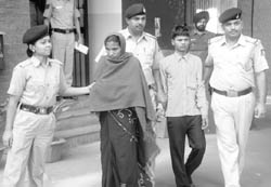 The woman and her paramour in police custody in Chandigarh